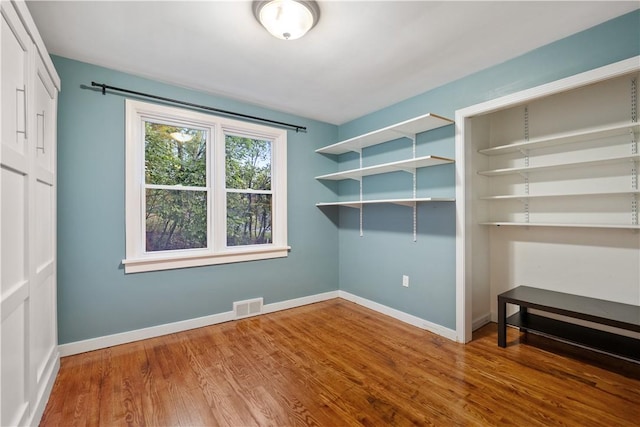 unfurnished room with wood-type flooring