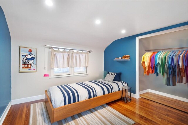 bedroom featuring lofted ceiling and hardwood / wood-style flooring