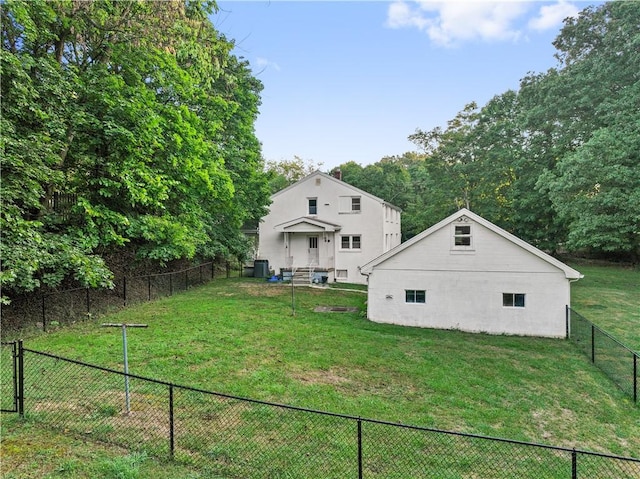 back of property featuring a yard