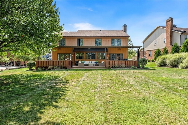 back of property featuring a lawn and an outdoor living space