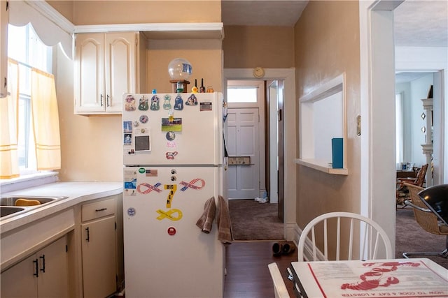 kitchen featuring dark hardwood / wood-style flooring and white fridge