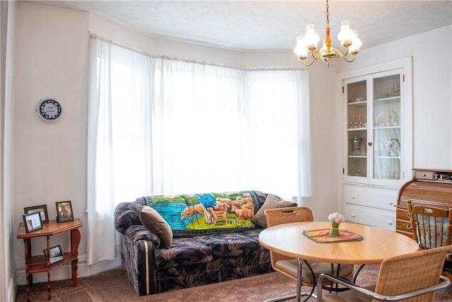 sitting room with an inviting chandelier, carpet flooring, and plenty of natural light