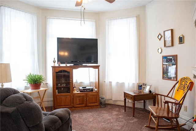 living room with ceiling fan and carpet