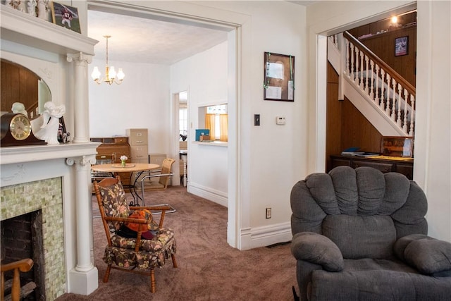 carpeted living room with a notable chandelier and a tile fireplace