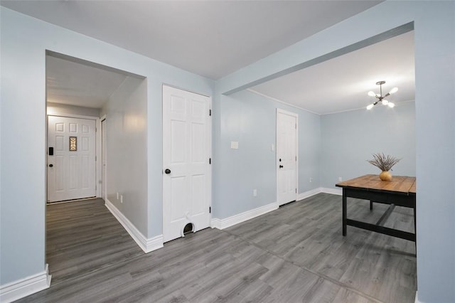 interior space featuring hardwood / wood-style floors and an inviting chandelier