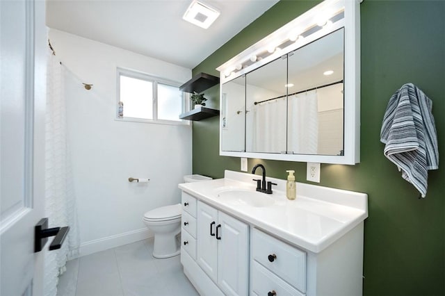 bathroom featuring toilet, vanity, and tile patterned flooring