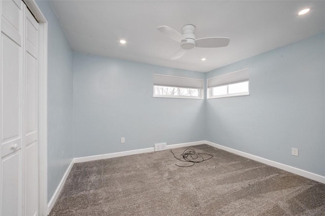 carpeted empty room featuring ceiling fan