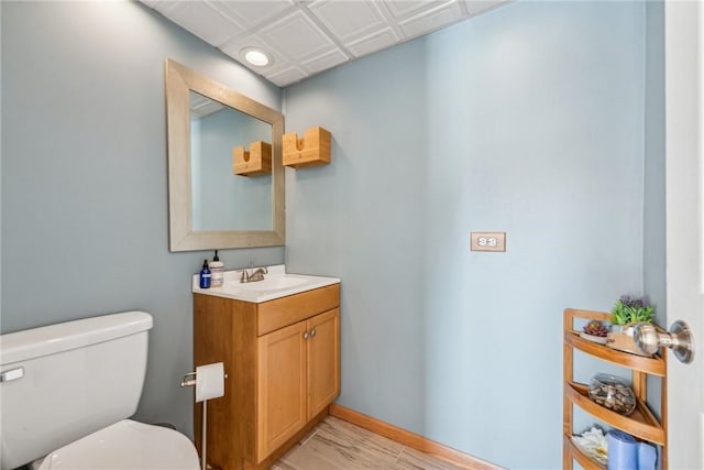 bathroom featuring hardwood / wood-style flooring, vanity, and toilet