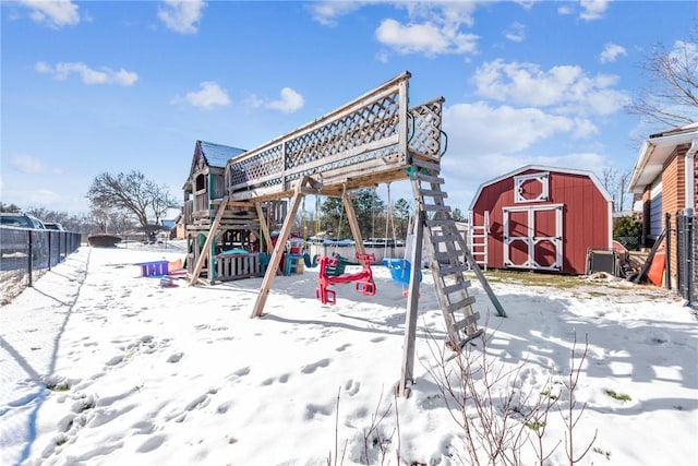 snow covered playground with a storage unit