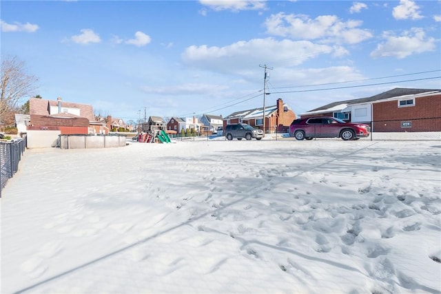 snowy yard with a playground