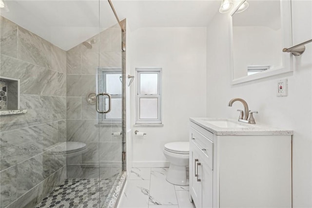 bathroom with an enclosed shower, vanity, and toilet