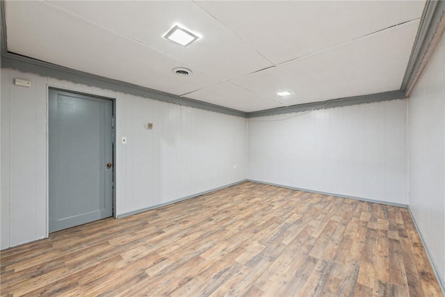 empty room featuring wood walls and wood-type flooring