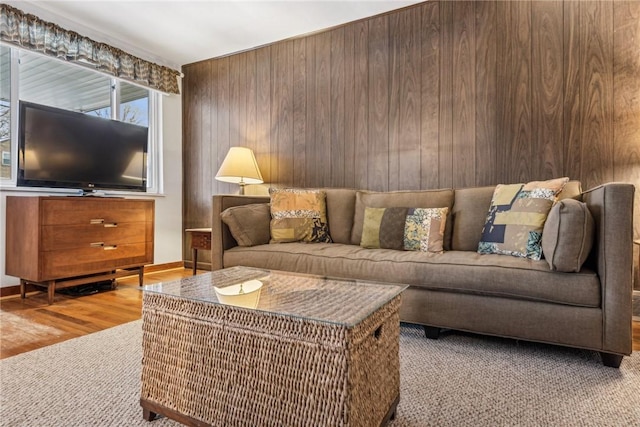 living room featuring wooden walls and hardwood / wood-style floors