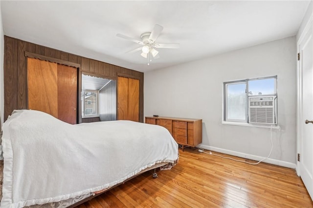 bedroom with wood-type flooring, ceiling fan, and cooling unit