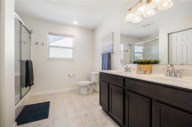 bathroom featuring vanity, tile patterned flooring, toilet, and walk in shower