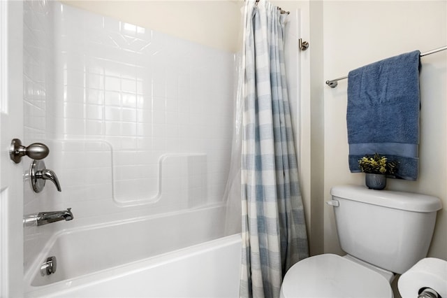 bathroom with toilet and shower / bath combo