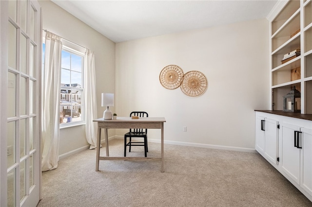 carpeted office space with french doors