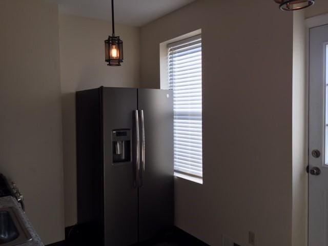 kitchen featuring stainless steel fridge with ice dispenser