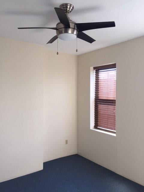 empty room featuring carpet flooring and a ceiling fan
