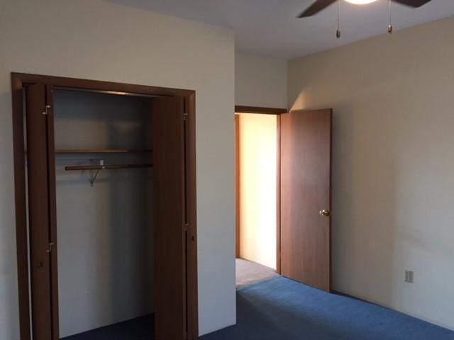 unfurnished bedroom with a closet, a ceiling fan, and carpet