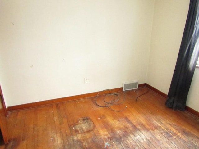 empty room featuring hardwood / wood-style flooring