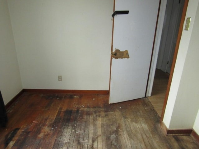 empty room with dark hardwood / wood-style flooring