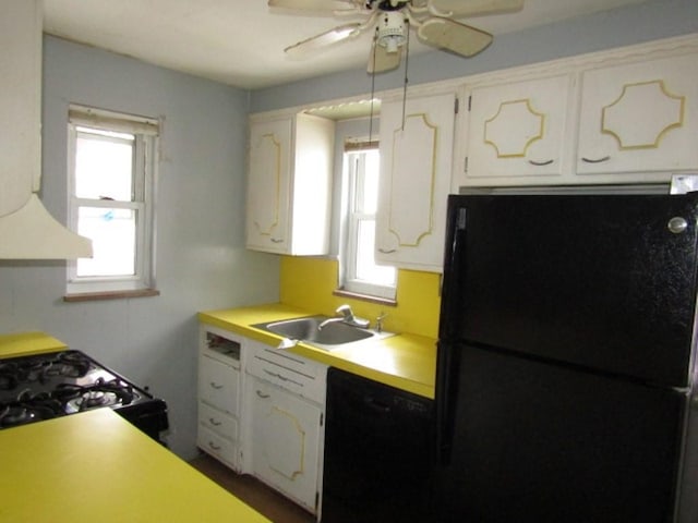 kitchen featuring black appliances, ceiling fan, white cabinetry, and sink