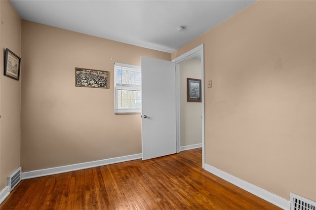 empty room featuring dark wood-type flooring