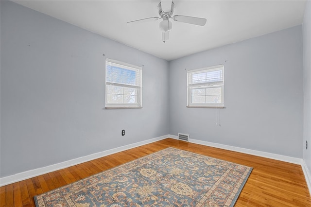 empty room with ceiling fan and wood-type flooring