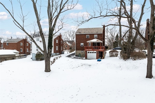 yard layered in snow featuring a garage