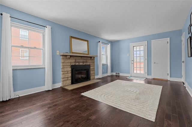 living room with a fireplace and dark hardwood / wood-style flooring