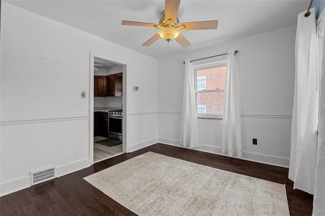 unfurnished room featuring ceiling fan and dark wood-type flooring