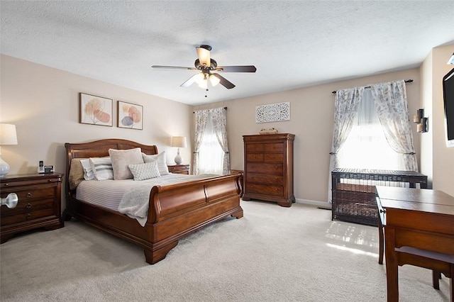 bedroom with ceiling fan, light carpet, a textured ceiling, and radiator