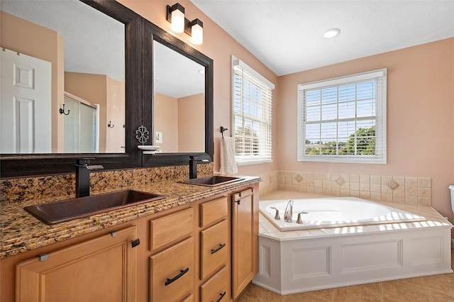 bathroom with independent shower and bath and vanity