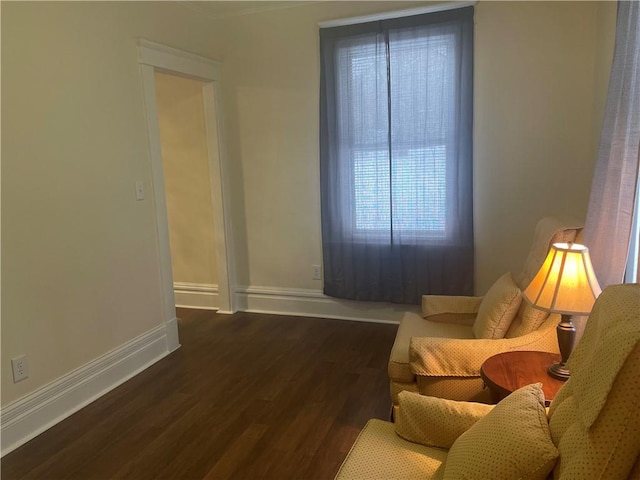 living room featuring baseboards and wood finished floors