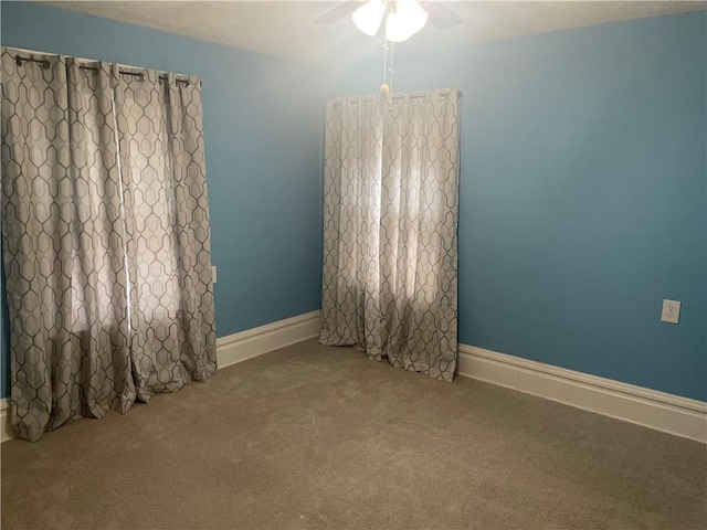 empty room with baseboards, carpet floors, and ceiling fan