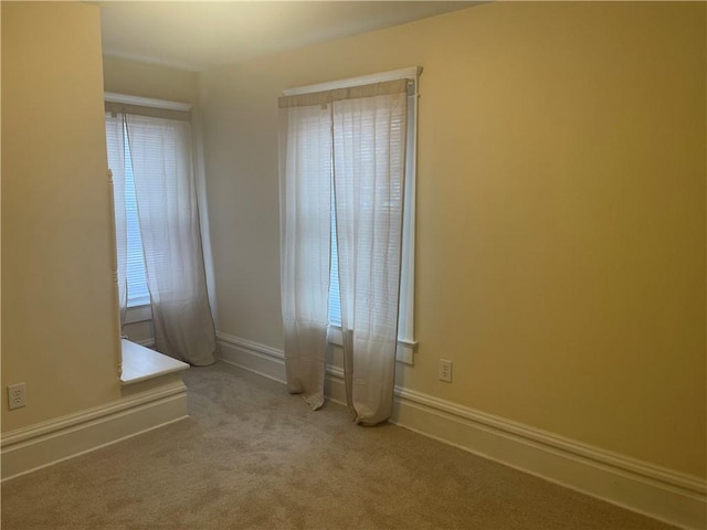 carpeted spare room with baseboards