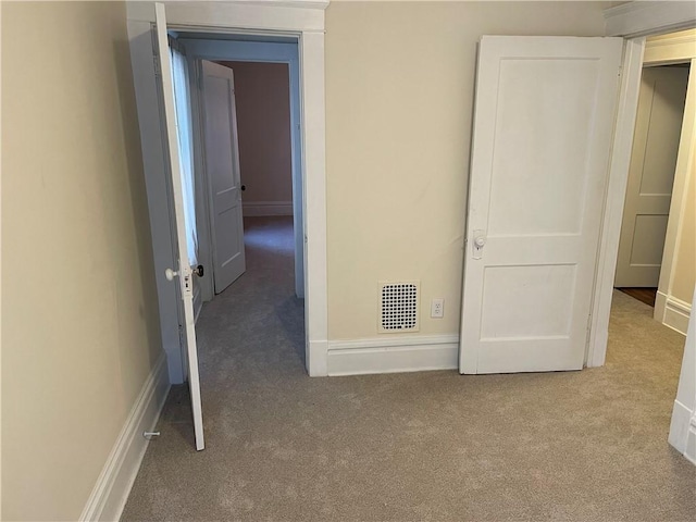 unfurnished bedroom with visible vents, carpet floors, and baseboards