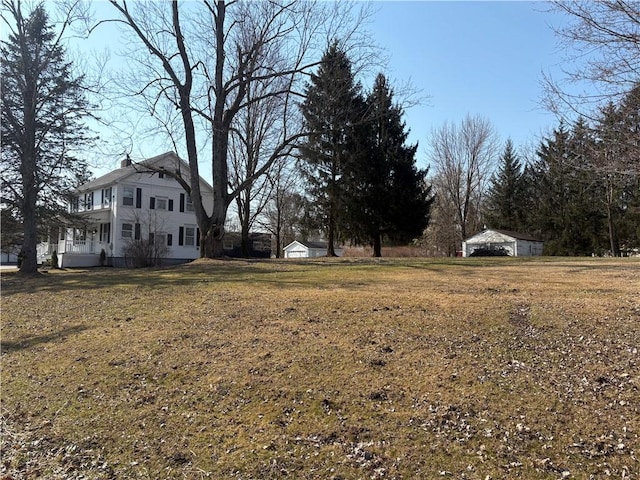 view of yard featuring an outbuilding and a storage unit