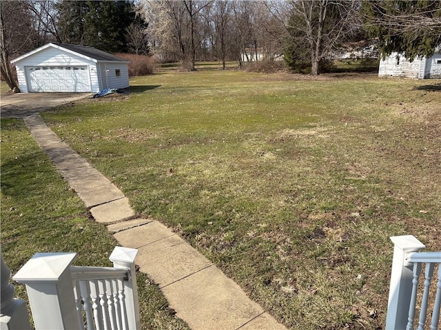 view of yard featuring an outdoor structure and a detached garage