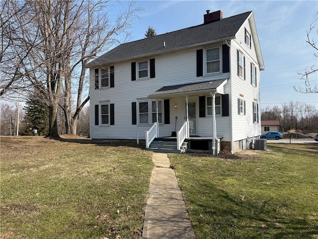 view of front facade featuring cooling unit, a front lawn, covered porch, and a chimney