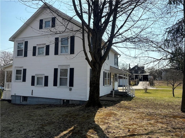 exterior space featuring entry steps and a lawn