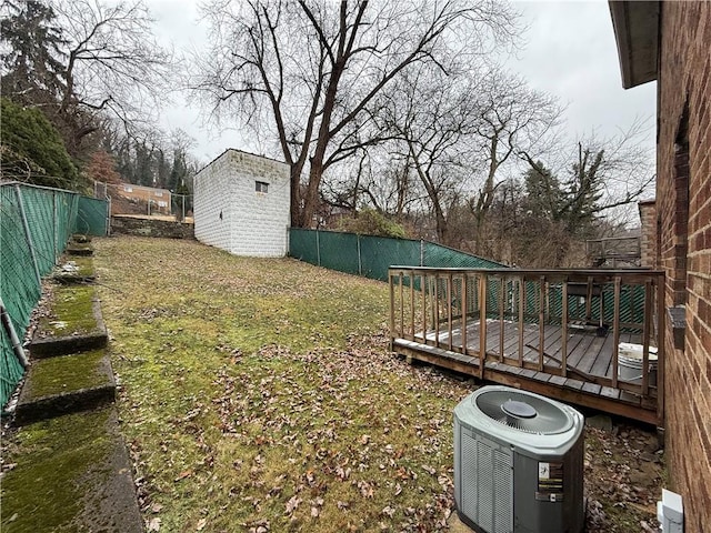 view of yard with a storage unit, central AC, and a wooden deck