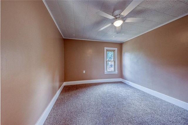 unfurnished room with ornamental molding, carpet, and ceiling fan