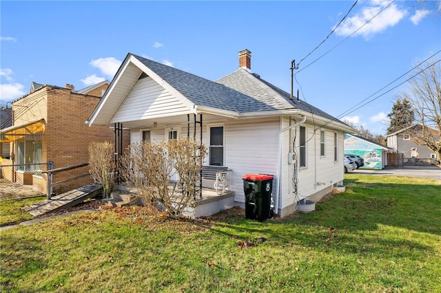 back of house featuring a yard