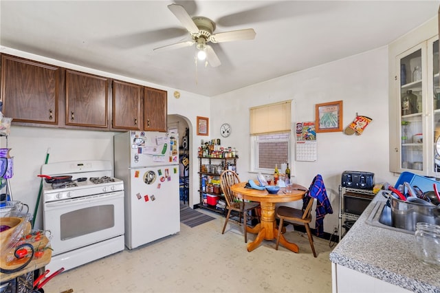 kitchen featuring sink, white appliances, ceiling fan, and dark brown cabinetry