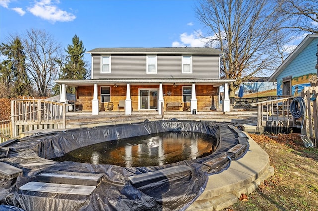 back of property with a porch