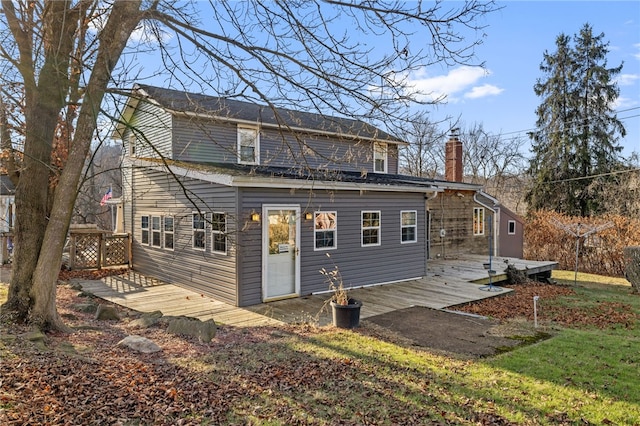 back of house with a yard and a wooden deck