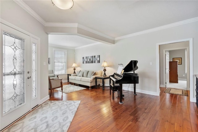 entryway with ornamental molding and hardwood / wood-style floors