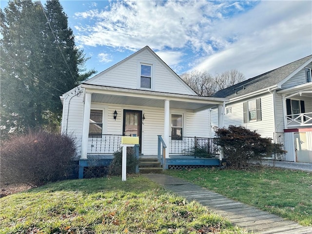 bungalow-style house featuring a porch and a front yard